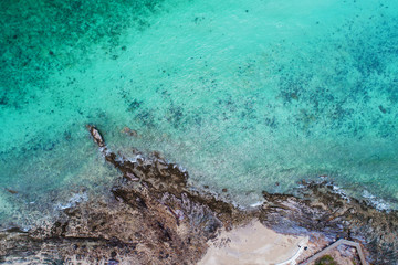Aerial top view of ocean waves, beach and rocky coastline and beautiful forest. Beautiful nature background. island background and tropical with tourist