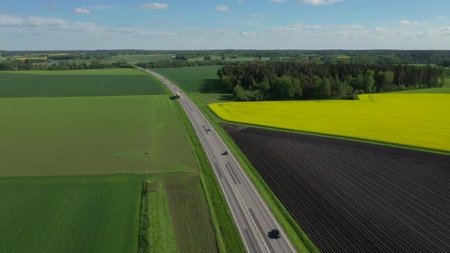 Aerial footage of highway through farm landscape in district Ostergotland, Sweden