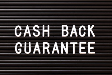 Fototapeta premium Black color felt letter board with white alphabet in word cash back guarantee background