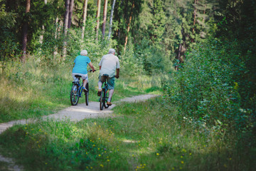 Fototapeta premium active senior couple riding bikes in nature