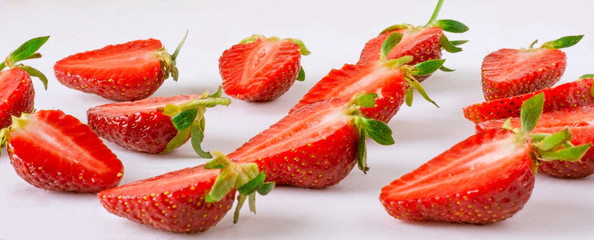 Cut along strawberries on a light background.