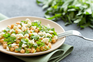 Healhty vegan lunch bowl with chickpeas, vegetable salad, close up.