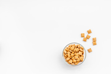 Puffins, corn cereals in bowls on white background top view space for text