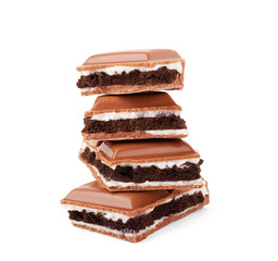 Chocolate broken into pieces on a white background