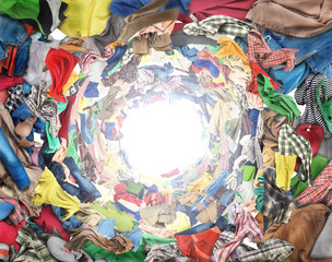 Sale concept. Top view to vortex of clothes. Donation.
