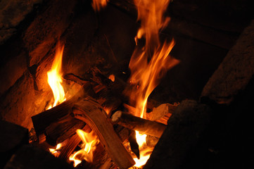 Abstract blurred fiery background. Flames blurred motion backdrop. Burning campfire in the night darkness. Firewood bonfire is blazing.