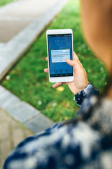 Woman hands holding smartphone with update error text on the screen. English text in dialog box.