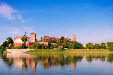  view at  Wawel castle in Cracow city (Krakow), Poland, from Vistula river (Wisla) quay in summer sunny with reflections in water