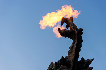 Symbol of Cracow - legendary polish wawel dragon monument with fire coming out from its mouth...
