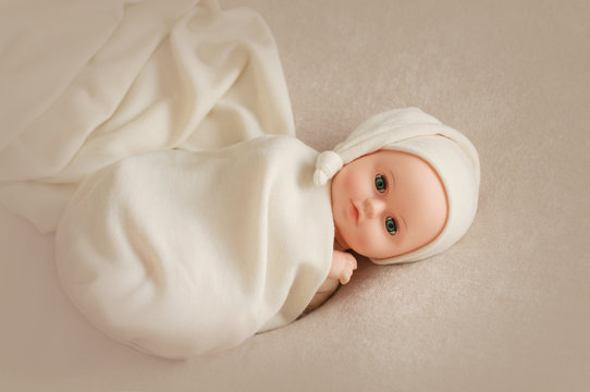 Baby doll toy photodraphed in a newborn style.
