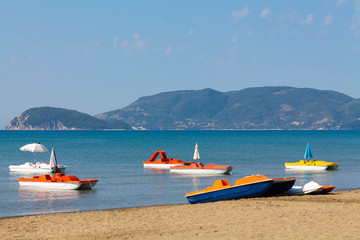 Sunny morning peaceful landscape with pedal boats. Zakynthos, Greece.