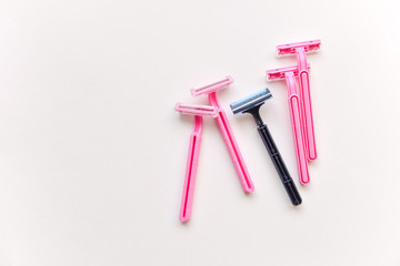 set of shaving razors. female and male, blue and pink color on a white isolated background