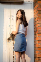 Portrait of thai china adult beautiful girl White shirt blue jeans relax and smile