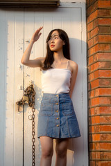 Fototapeta premium Portrait of thai china adult beautiful girl White shirt blue jeans relax and smile