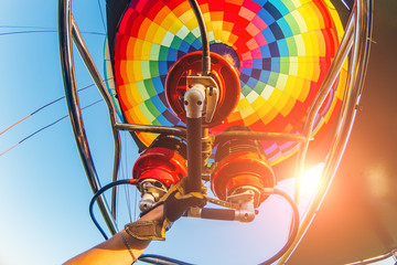 Hot air balloon or aerostat, bright burning fire flame from gas burner equipment, close up from...