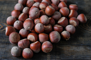 Hazelnut close up. Hazelnuts nuts on wooden background.