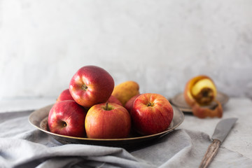 Still life with apples on a metallic plate