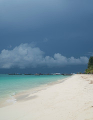Sandy beach and sea with boats over cloudy sky. Koh Lipe beautiful tropical island in Thailand
