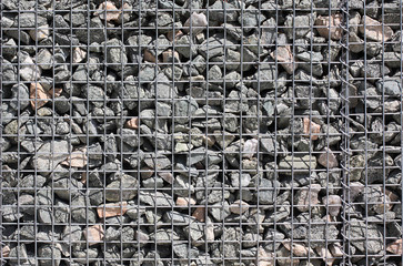 Grey ground stone rubble background of many small stones