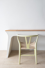 Minimalist architect designer concept with green classic chair and modern table on wooden floor with white wall background.