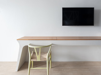 Minimalist architect designer concept with green classic chair , television and modern table on wooden floor with white wall background.