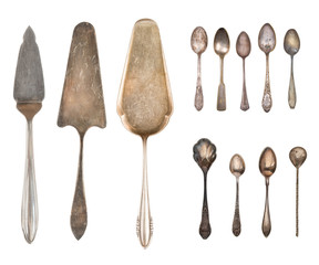 Vintage Silverware, antique spoons, forks, knives, ladle, cake shovels, kettle, tray and ice bucket isolated on isolated white background. Antique silverware. Retro.