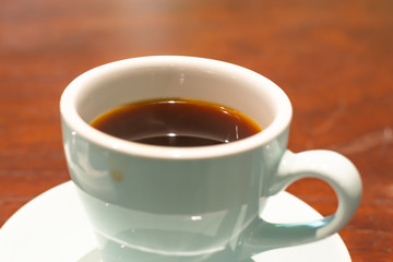 Cup of americano coffee  at cafe with nature background.