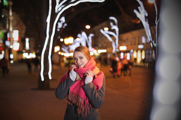 Beautiful young woman spending time in city at night