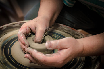 Women's hands on a potter's wheel