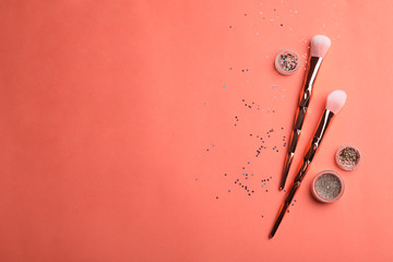 Flat lay composition with beauty accessories and space for text on coral background