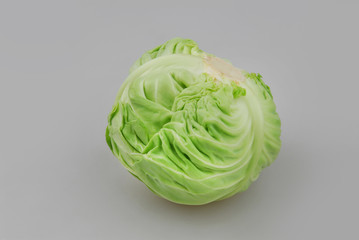 Head of fresh white cabbage isolated on gray. Close-up. Side view.