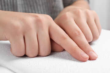 Blind person reading book written in Braille, closeup