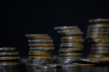 coins stacked on each other in different positions, rows for finance and business concept.