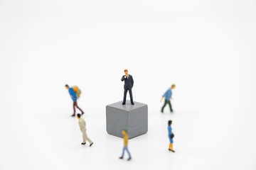 Miniature people businessmen standing on white Jigsaw. The concept used in selecting personnel to participate in the organization. with copy space.