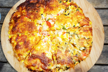 Custom made pizzas at home on appetizing brown wooden trays