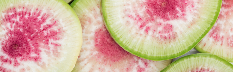 panoramic shot of cut raw fresh watermelon radish purple slices