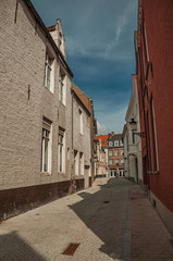 Quiet empty street with brick buildings at Bruges