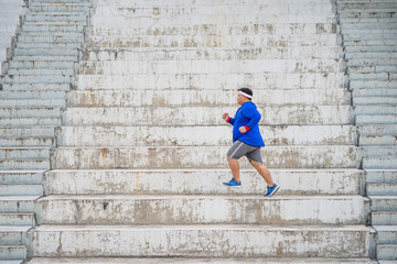 The fat man was running up the stairs. He lost weight.