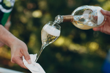 Waiter pouring champagne into a glass