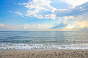 Beautiful beach and sky after the rain with the sun's light penetrating through the clouds.