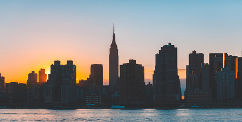 Fototapeta na wymiar New York skyline, skyscrapers silhouette at dusk