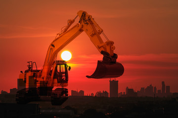 Excavator model on full sunset background in cityscape building concept, With double exposure