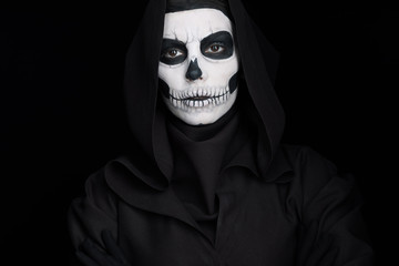 woman with skull makeup looking at camera isolated on black