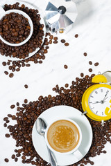 espresso cup and alarm clock, conceptual photography, vertical top view