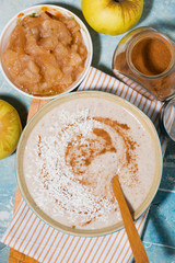 healthy linen porridge with apple and cinnamon, top view vertical