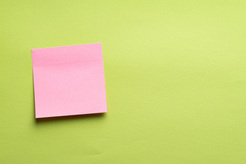 Blank pink sticker on green color background. Copy space Creative vintage background. Template for lettering