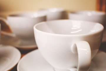 Fototapeta na wymiar Several white ceramic coffee mugs