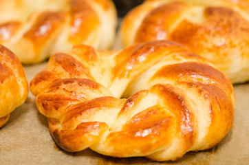 Homemade baked sweet rolls on an oven tray