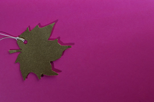 gold leaf paper tag on pink background