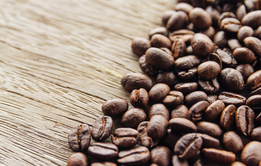 Coffee beans on old wood background